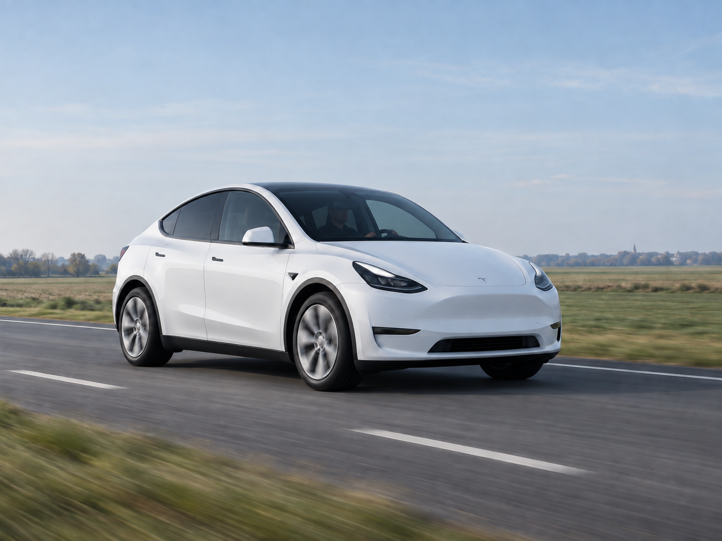 Tesla Model Y blanche ACH CAB sur une route des Hauts-de-France